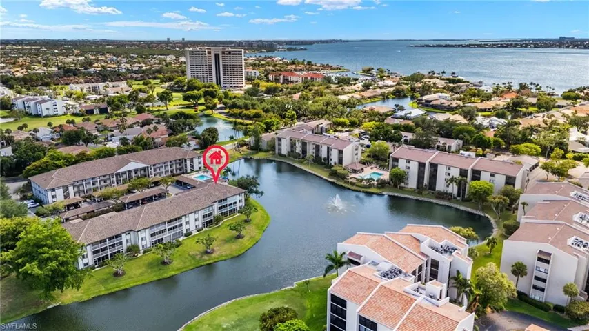 Drone / aerial view of a large body of water and apartment complex / building