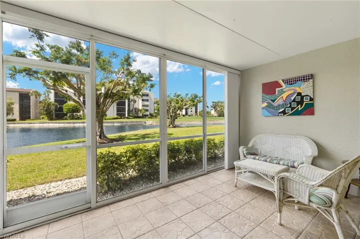 Sunroom featuring a water view and healthy amount of natural light