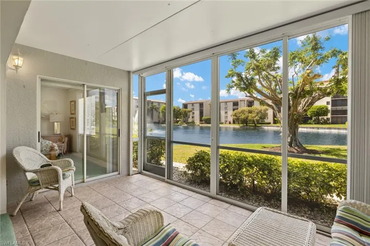 Sunroom / solarium featuring a water view