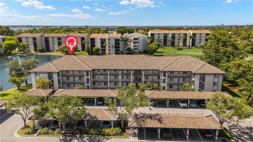 Bird's eye view of apartment complex and a nearby body of water