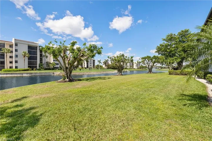 View of grassy yard with a water view