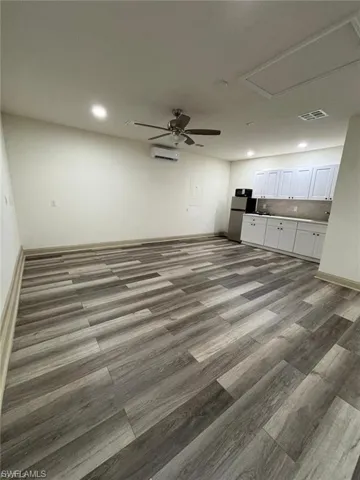 Wood-finish flooring throughout, complemented by a ceiling fan