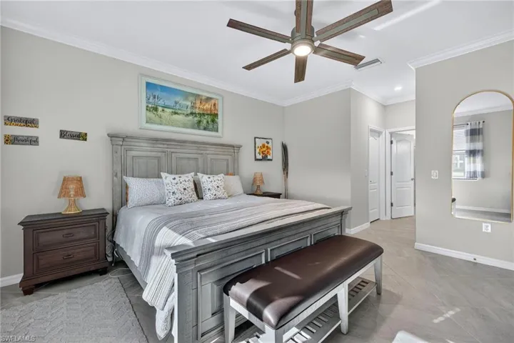 Bedroom featuring ornamental molding and ceiling fan