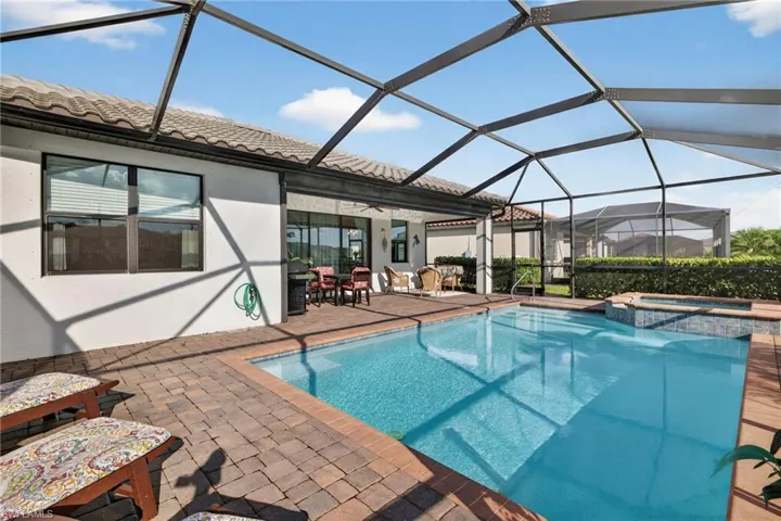 View of swimming pool featuring a sunroom, a patio area, and a lanai