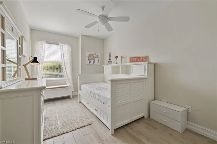 Bedroom featuring light wood-style flooring and a ceiling fan