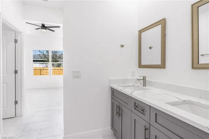 Bathroom with ceiling fan and vanity