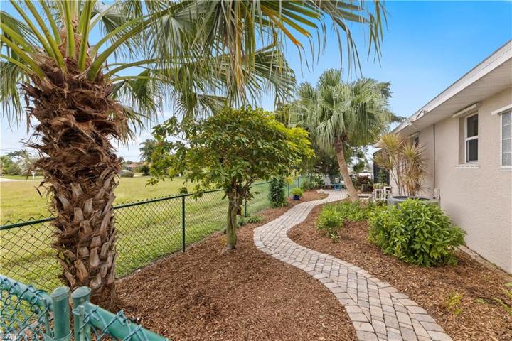 Left Side of Lot Fenced with gate, Paver Walkway & Seating Area
