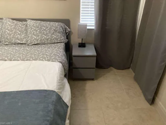 Cream-toned tile flooring complements neutral wall tones