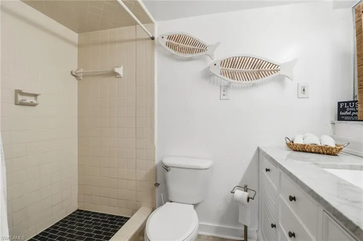 Full bath featuring vanity and a shower stall