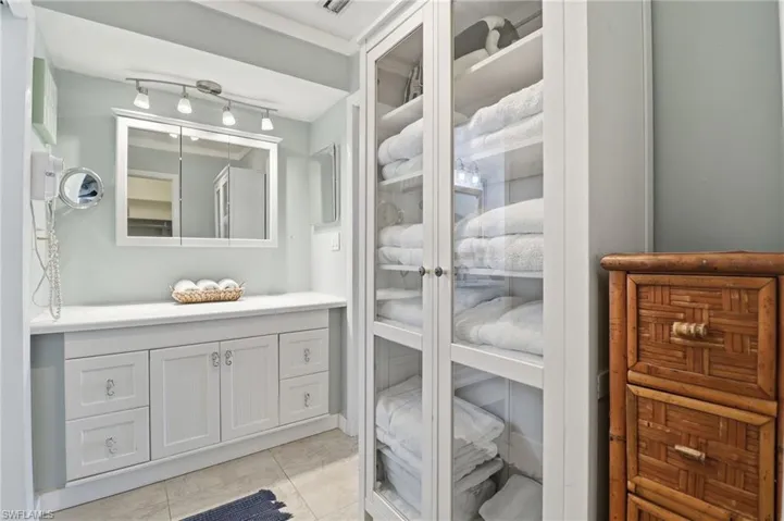 Bathroom featuring vanity, a closet, and light tile patterned flooring