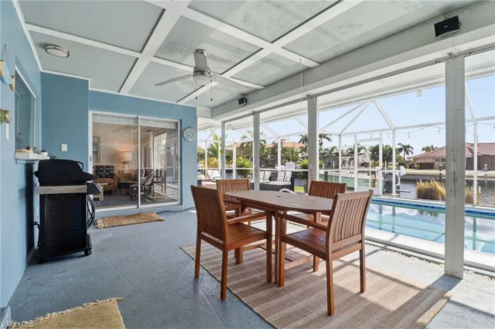 Sunroom / solarium with coffered ceiling, a water view, and plenty of natural light