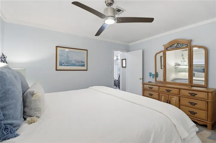 Bedroom with ornamental molding and ceiling fan