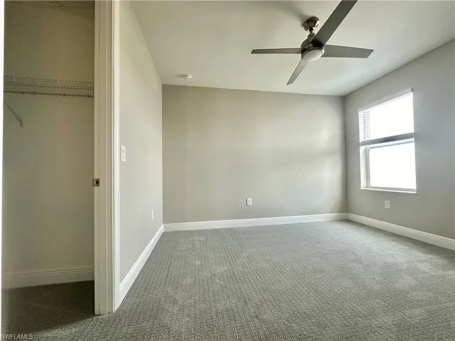 Unfurnished bedroom with carpet floors and ceiling fan