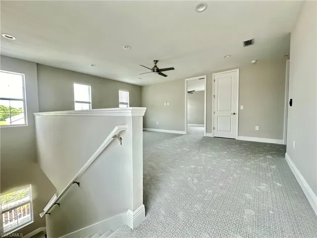 Unfurnished room with light carpet, ceiling fan, and recessed lighting