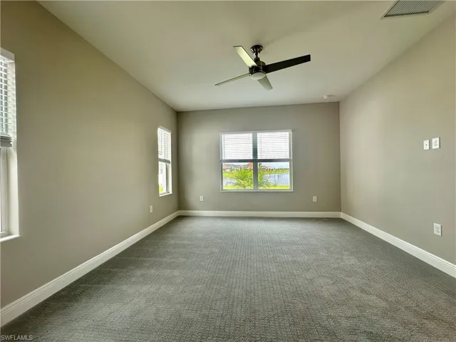 Spare room with ceiling fan and carpet floors