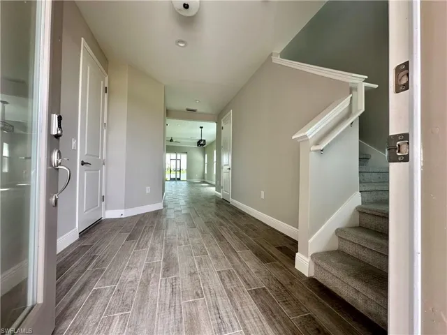Entryway with wood finish floors and a ceiling fan