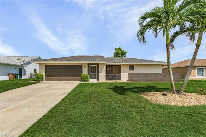 Ranch-style house with a garage and a front yard