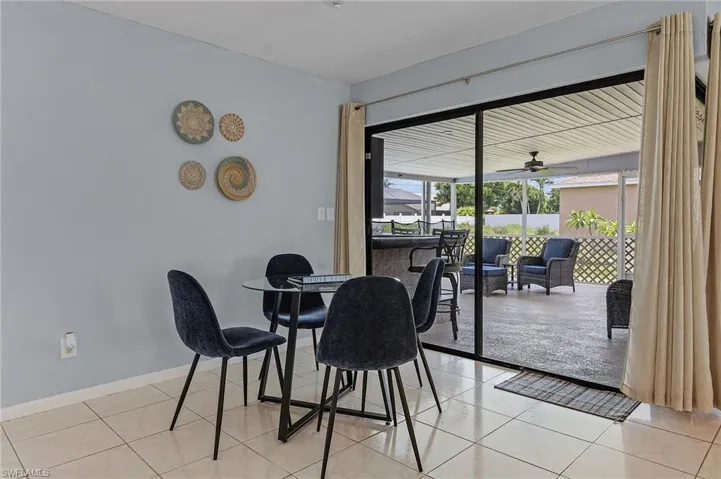 Tiled dining area featuring ceiling fan