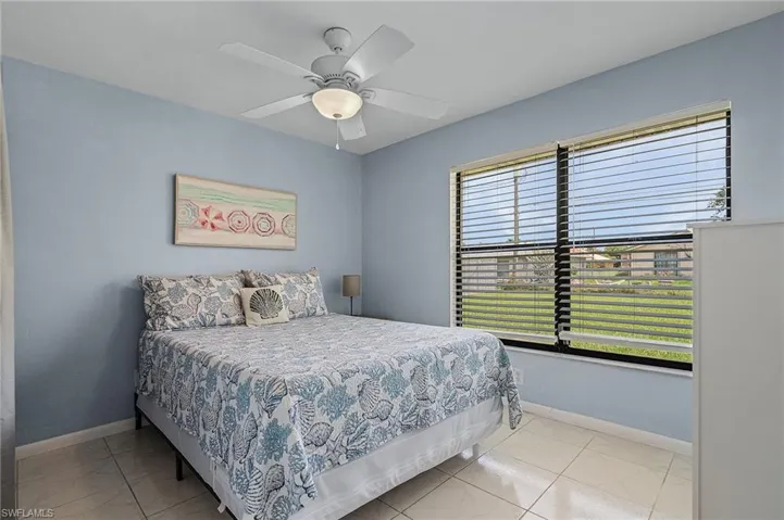 Bedroom featuring light tile patterned floors and ceiling fan
