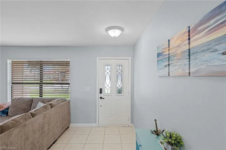 Entrance foyer featuring light tile patterned flooring and a wealth of natural light