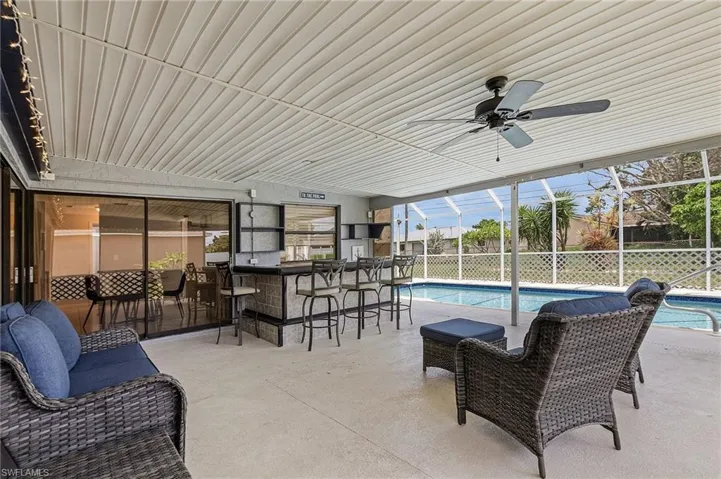 View of swimming pool with a lanai, a patio area, and exterior bar