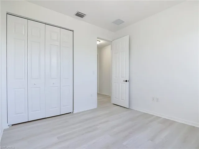 Light wood-finish flooring complements white walls