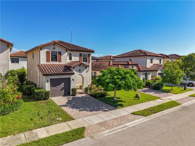 Mediterranean-style residence featuring a tile roof and stucco exterior