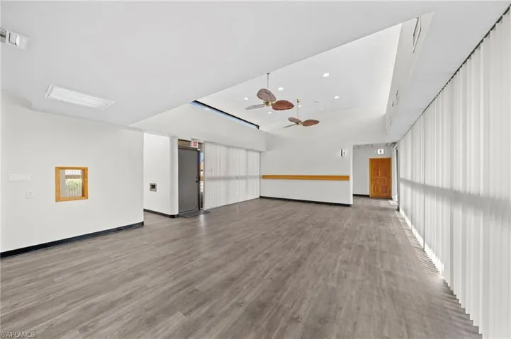 Unfurnished room with ceiling fan and light hardwood / wood-style floors