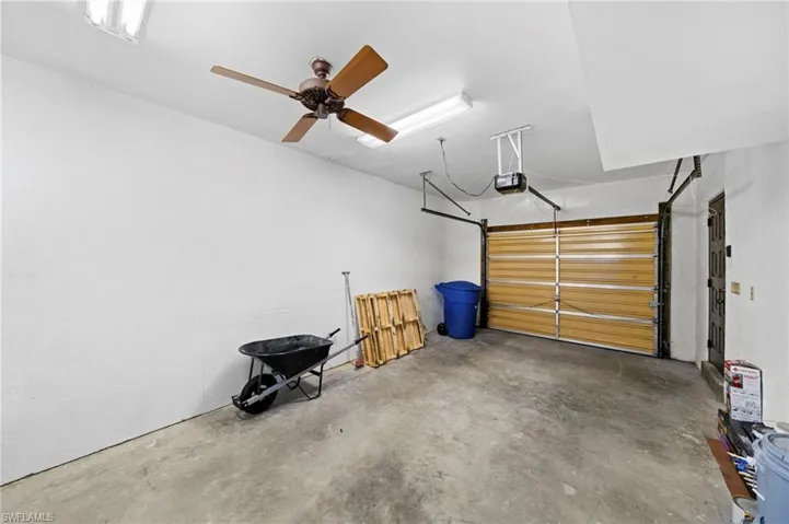 Garage featuring a garage door opener and ceiling fan