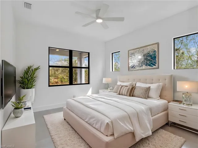 Bedroom featuring multiple windows and ceiling fan. This photo is virtually staged.