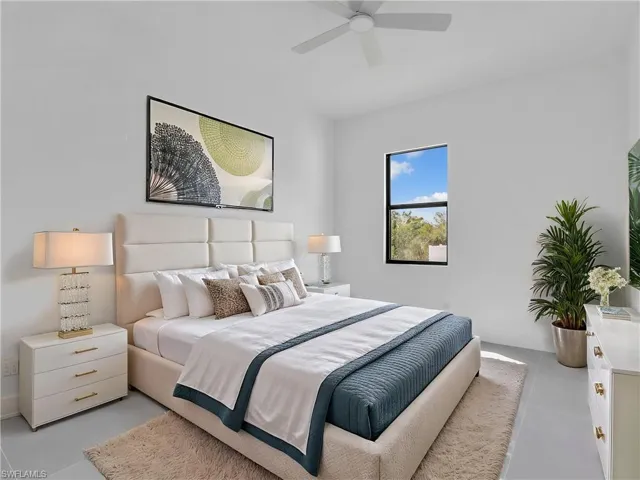 Bedroom with a ceiling fan and baseboards. This photo is virtually staged.