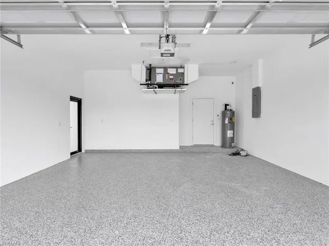 Epoxy Floored Garage with electric panel and electric water heater