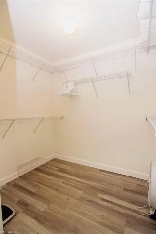 Spacious en suite walk in closet that features newly installed luxury vinyl plank flooring.