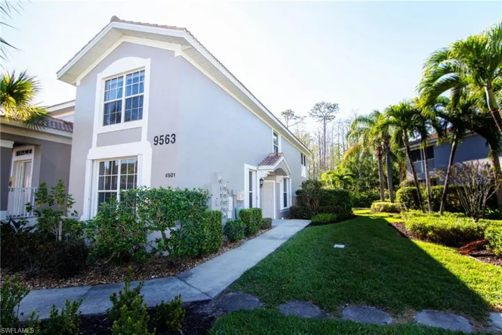Private entry on side of building with landscaped walkway.