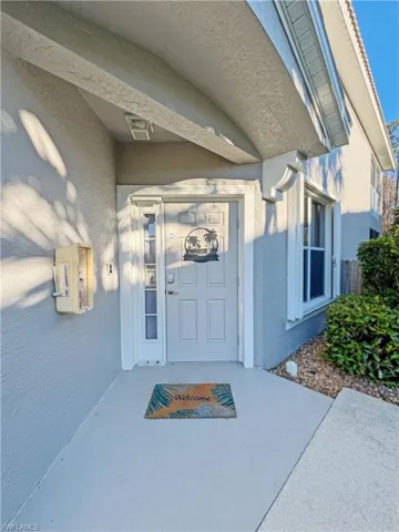 Private entry on side of building with landscaped walkway.