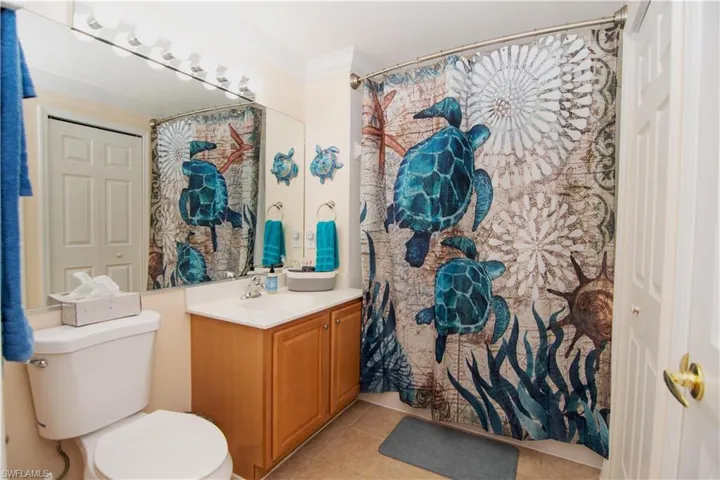 Guest bath with a large linen closet and coastal flair.