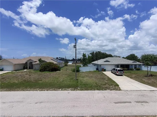 Light pole is center mark for lot, directly across the street.
