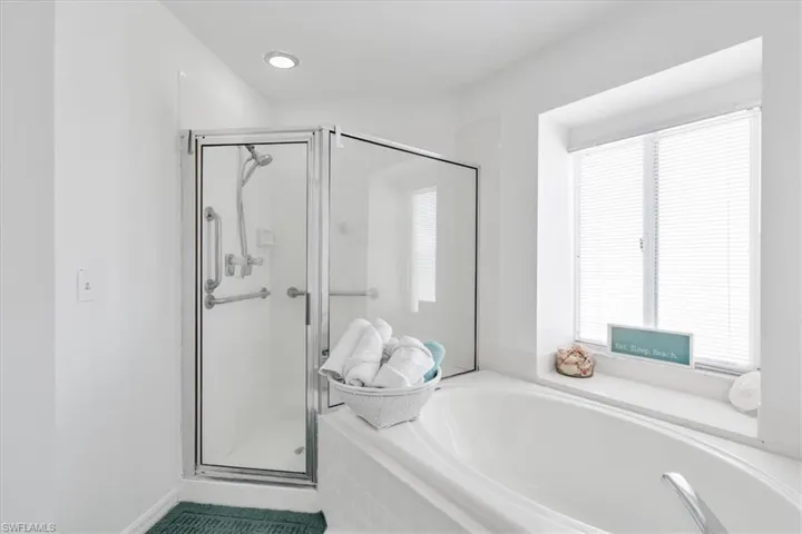 Full bathroom with a stall shower and a bath