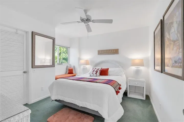 Bedroom with ceiling fan and carpet