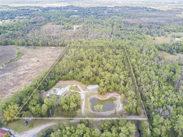 Aerial view of property's location with property boundaries highlighted and a forest