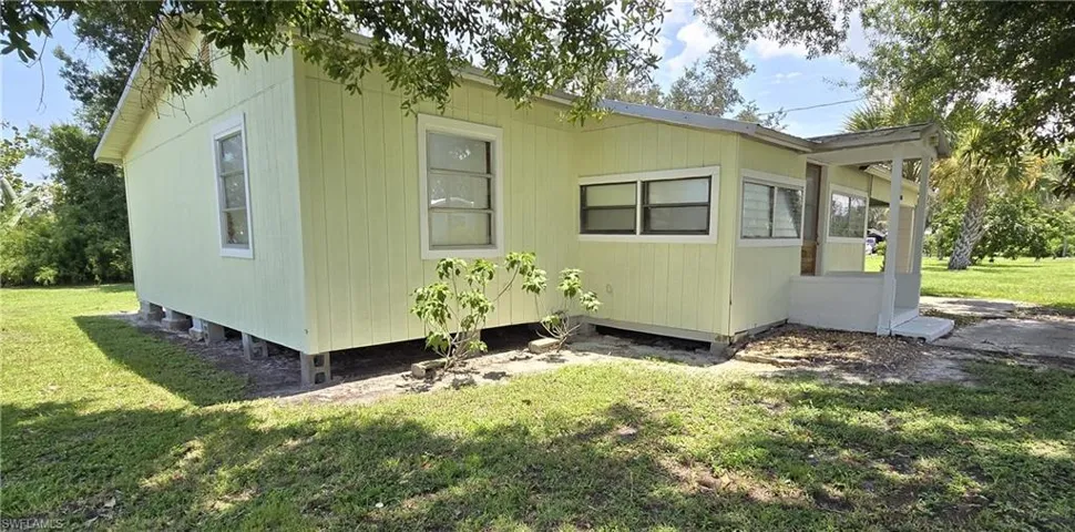 Back of property with a yard