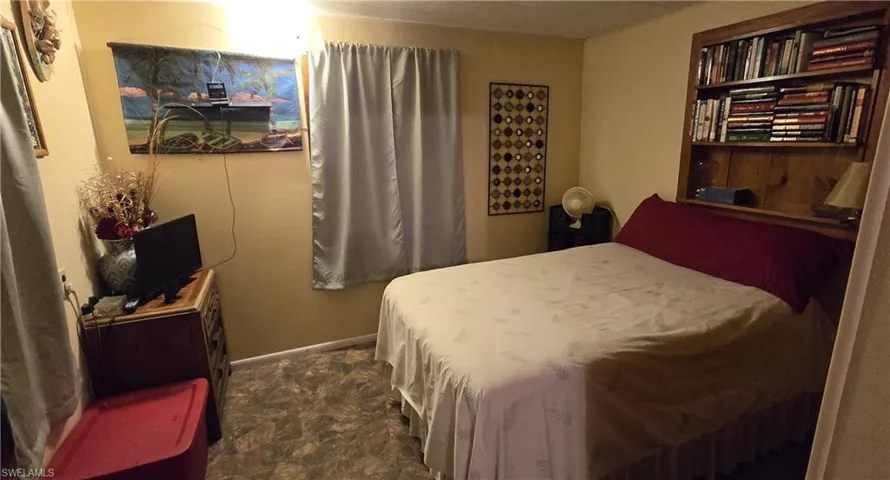 Bedroom featuring dark colored carpet