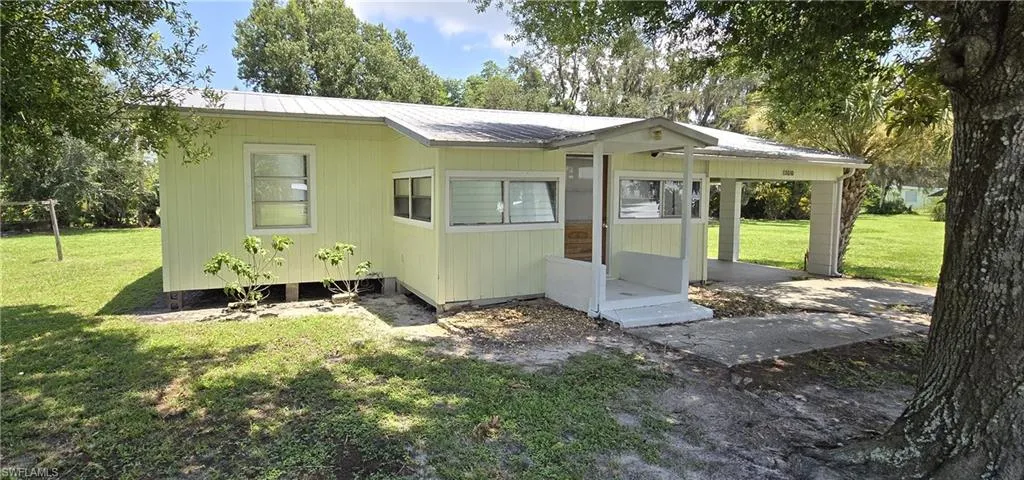 Rear view of property featuring a yard
