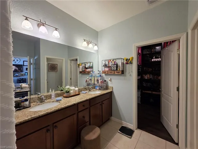 Bathroom with double vanity, and entrance to the massive walk in closet