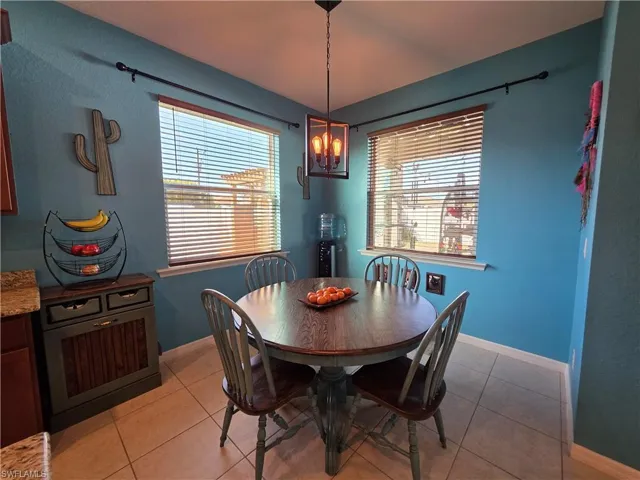 Dining room with light tile patterned flooring and plenty of natural light