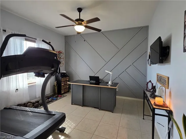 Office/ Den with ceiling fan and Decorative Wall