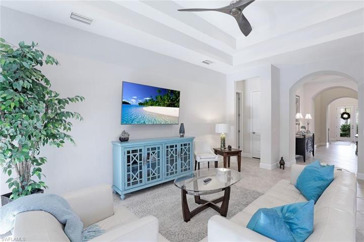 Family Room with beautiful arches and HIGH ceilings leading to the front of the home.