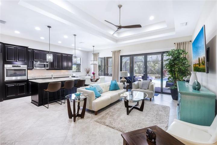 The Open Floor Plan is perfect for entertaining and boasts upgraded cabinetry, a walk-in pantry, plenty of storage space, high tray ceilings, and seamlessly merges the indoor/outdoor living space.