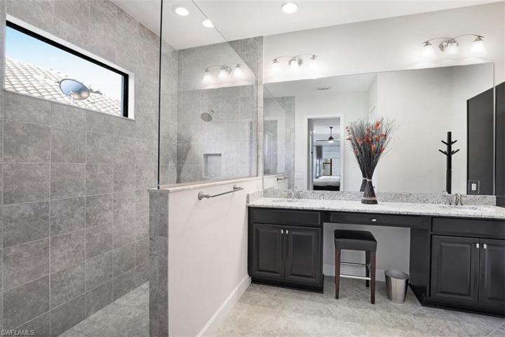 Owner bath features a large walk-in shower, dual sinks, and plenty of cabinet space.