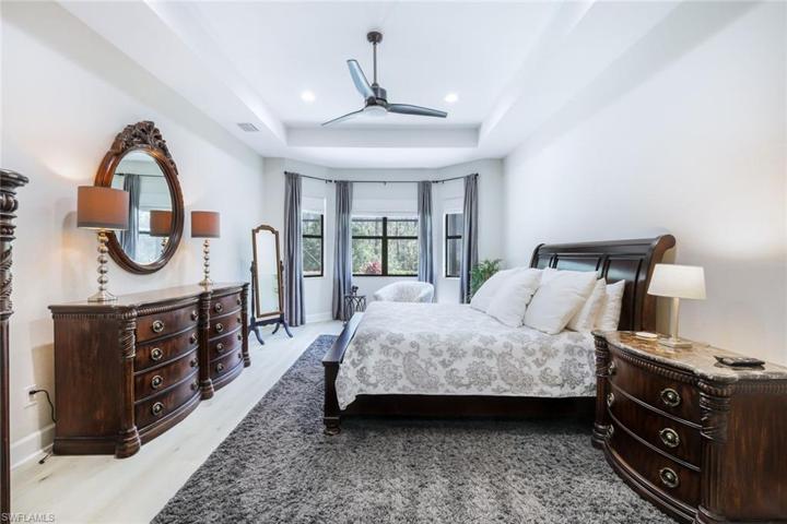 Owner suite is quite spacious and includes large his and her walk-in closets, high tray ceilings, new flooring, and plenty of natural light.